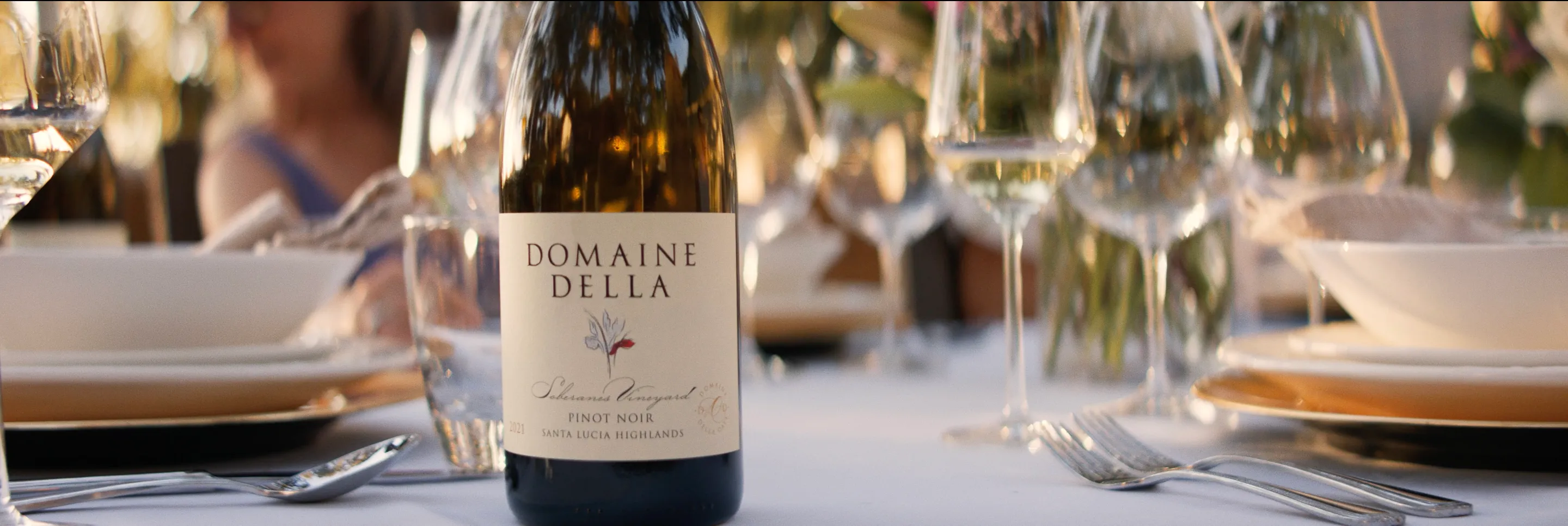 Domaine Della bottle with an elegant place setting